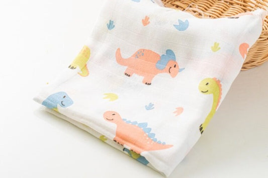 MUSLIN SWADDLE IN DINOSAUR PRINT